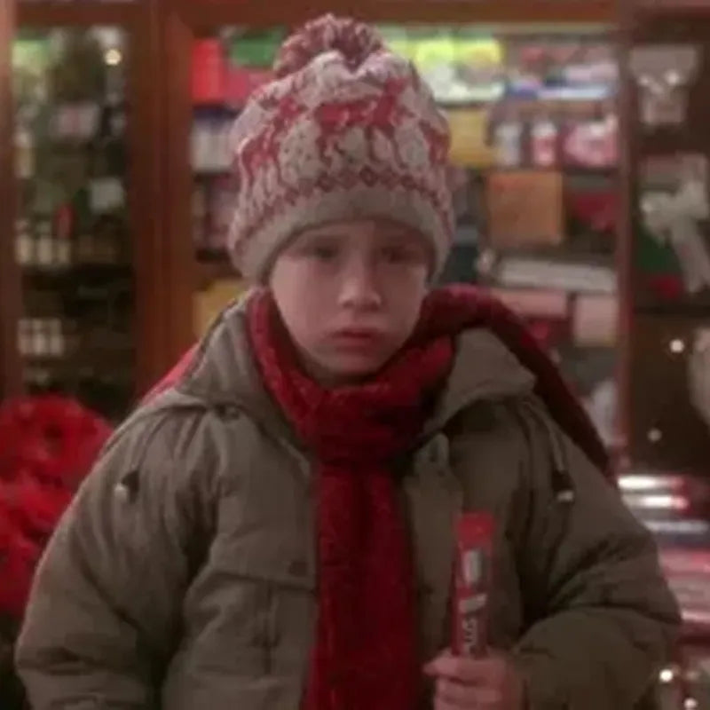 Person wearing a winter hat and scarf, holding a drink in a store setting