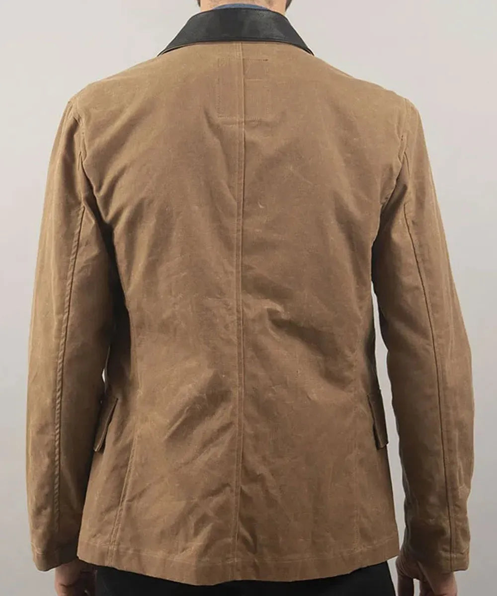 Brown jacket worn by a person on a plain background
