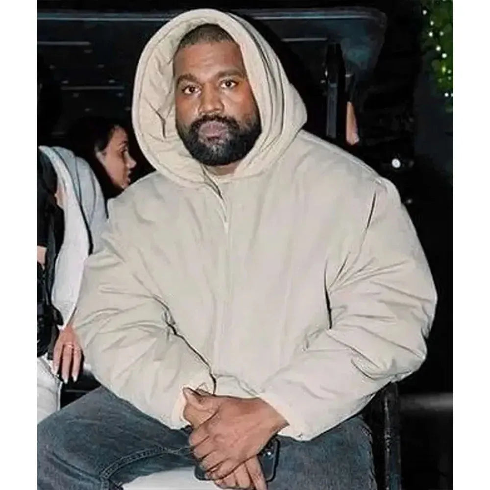 Person wearing a beige hoodie sitting in a car