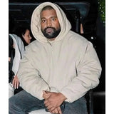 Person wearing a beige hoodie sitting in a car